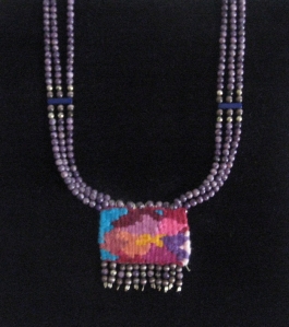 Abstract floral design handwoven pendant with dyed fossil beads